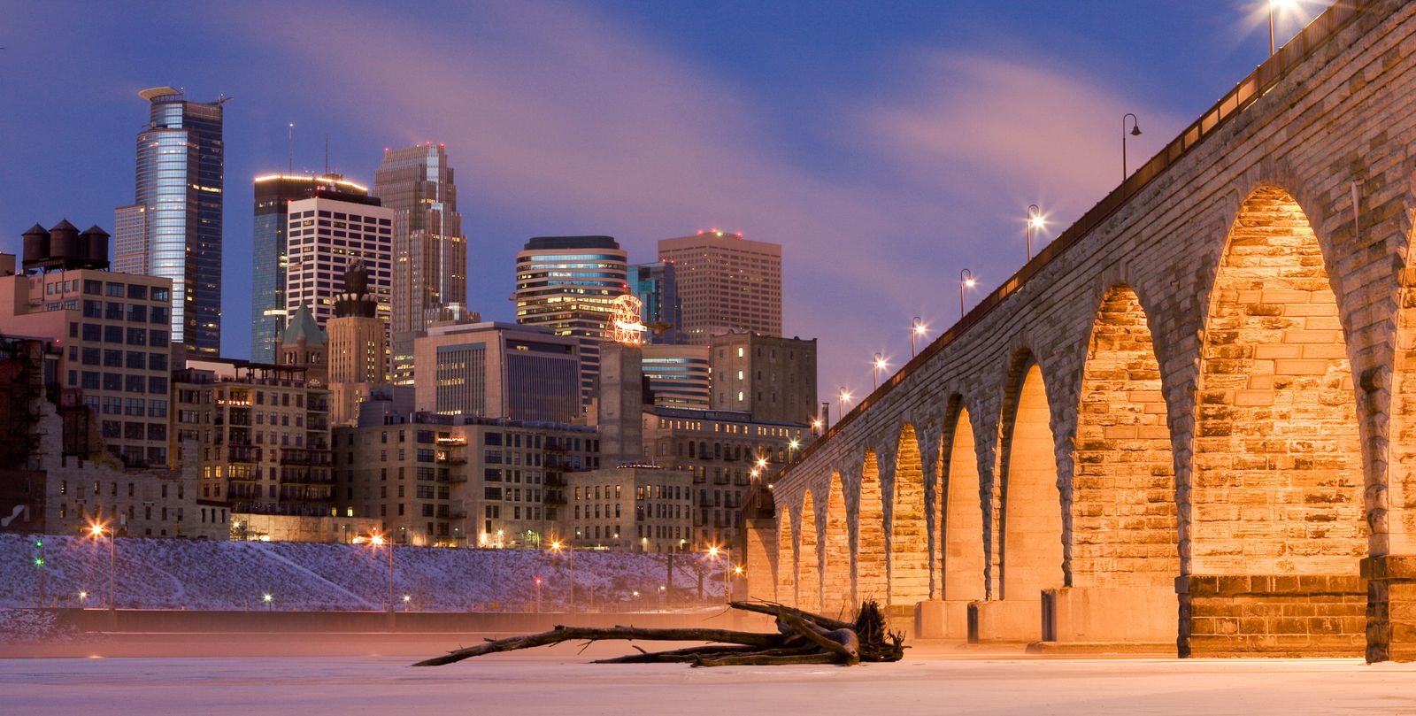 The Stone Arch Bridge and downtown Minneapolis on a snowy winter evening